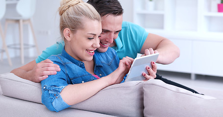 Image showing couple relaxing at  home with tablet computers