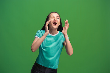 Image showing Isolated on pink young casual woman shouting at studio