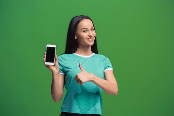 Image showing Portrait of a smiling woman showing blank smartphone screen