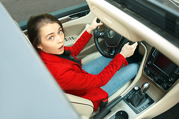 Image showing Driving around city. Young attractive woman driving a car