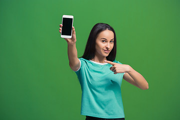 Image showing Portrait of a smiling woman showing blank smartphone screen