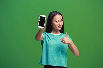 Image showing Portrait of a smiling woman showing blank smartphone screen