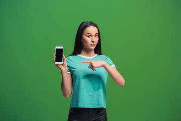 Image showing Portrait of a smiling woman showing blank smartphone screen