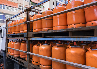 Image showing Truck full of orange gas cylinders transporting butane