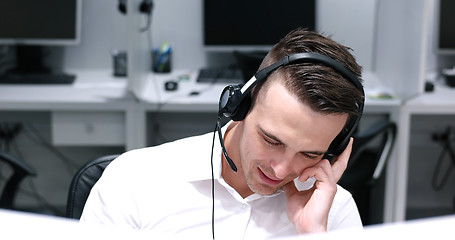 Image showing male call centre operator doing his job