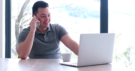 Image showing businessman working using a laptop in startup office