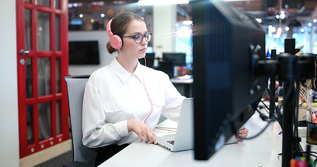 Image showing businesswoman using a laptop in startup office