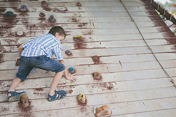 Image showing little boy make climbing in the adventure park.