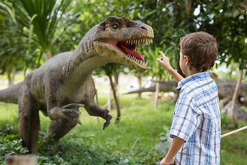 Image showing little boy playing in the adventure dino park.