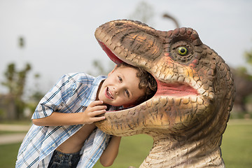 Image showing little boy playing in the adventure dino park.