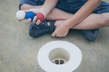 Image showing Happy little boy playing mini golf playing mini golf