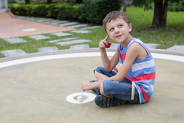 Image showing Happy little boy playing mini golf playing mini golf