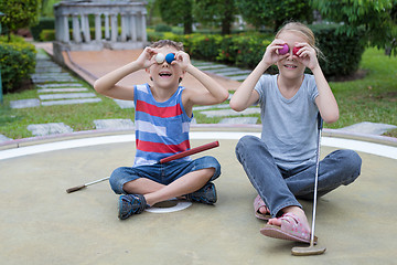 Image showing Happy brother and sister playing mini golf 