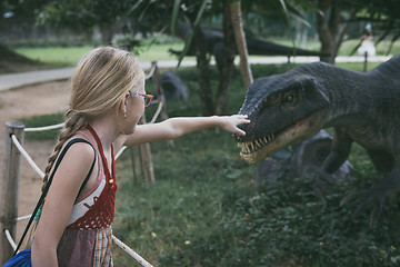 Image showing little girl playing in the adventure dino park.