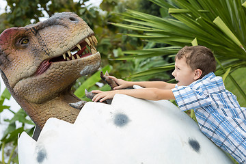 Image showing little boy playing in the adventure dino park.