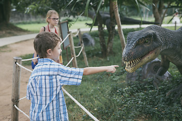 Image showing little boy playing in the adventure dino park.