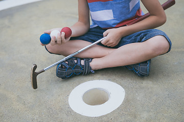 Image showing Happy little boy playing mini golf playing mini golf