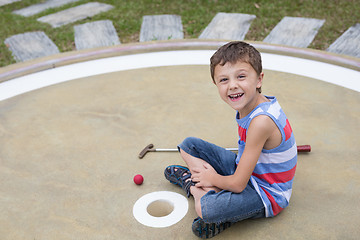 Image showing Happy little boy playing mini golf playing mini golf