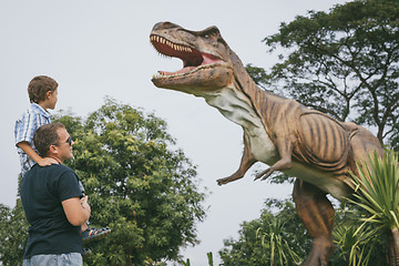 Image showing Father and son playing in the adventure dino park.