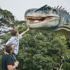 Image showing Father and son playing in the adventure dino park.