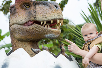 Image showing Father and baby son playing in the adventure dino park.