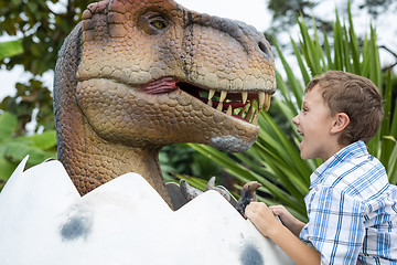 Image showing little boy playing in the adventure dino park.