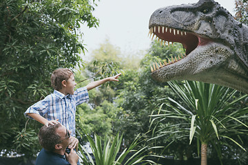 Image showing Father and son playing in the adventure dino park.