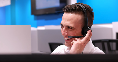 Image showing male call centre operator doing his job