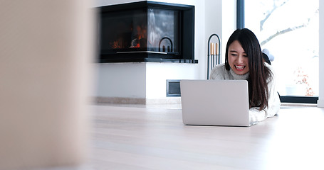 Image showing Asian woman using laptop on floor