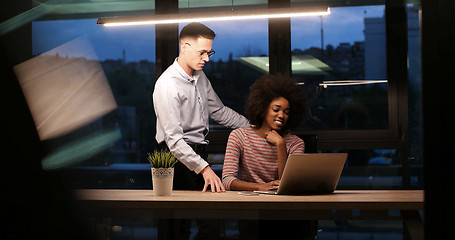 Image showing Multiethnic startup business team in night office