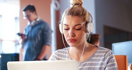 Image showing businesswoman using a laptop in startup office