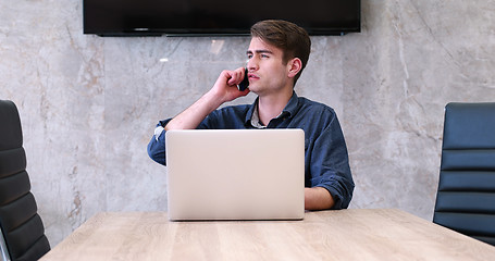 Image showing businessman working using a laptop in startup office