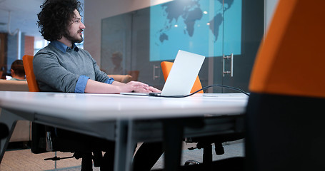 Image showing businessman working using a laptop in startup office