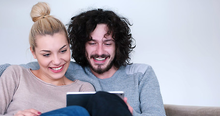 Image showing couple relaxing at  home with tablet computers