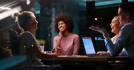 Image showing Multiethnic startup business team in night office