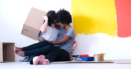 Image showing young multiethnic couple playing with cardboard boxes