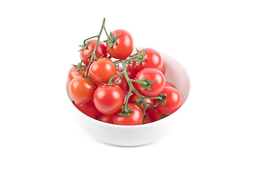Image showing Fresh organic cherry tomatoes bunch on ceramic bowl isolated on 