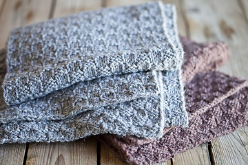 Image showing Knitted woolen grey and brown scarves