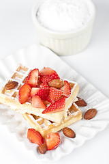 Image showing Belgium waffers with sugar powder, strawberries and almonds on c