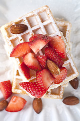 Image showing Belgium waffers with sugar powder, strawberries, almonds and cho