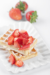 Image showing Belgium waffers with sugar powder and strawberries on ceramic pl