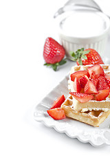 Image showing Belgium waffers with sugar powder and strawberries on ceramic pl