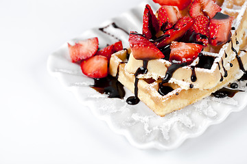 Image showing Belgium waffers with sugar powder, strawberries and chocolate on