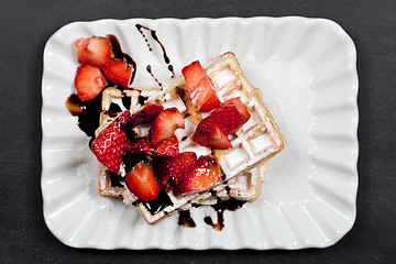 Image showing Belgium waffers with sugar powder, strawberries and chocolate on