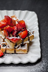 Image showing Belgium waffers with sugar powder, strawberries and chocolate on