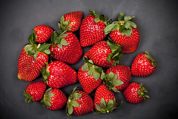 Image showing Fresh ripe strawberries on black background.