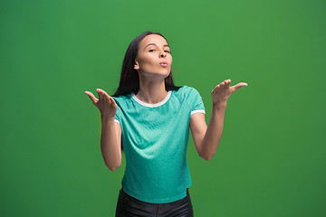 Image showing Portrait of attractive cute girl with bright makeup with kiss isolated over green background