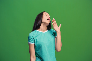 Image showing Beautiful bored woman bored isolated on green background