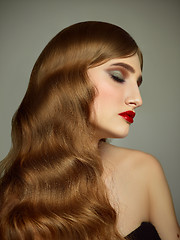 Image showing Close-up indoor portrait of lovely girl with colorful hair. Studio shot of graceful young woman with long haircut