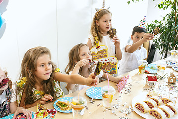 Image showing Girl birthday decorations. table setting with cakes, drinks and party gadgets.